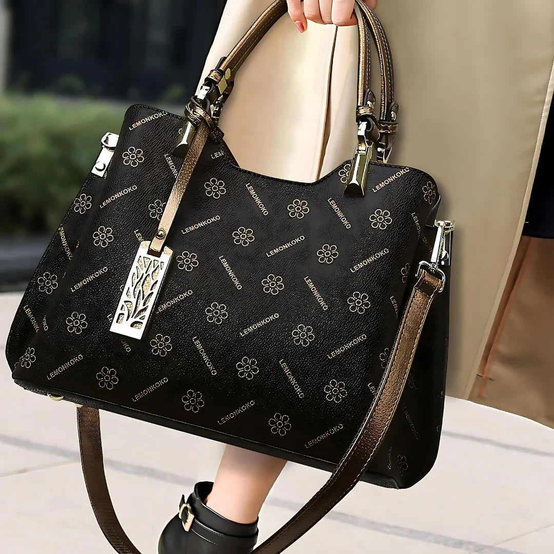 Black LEMONKOKO floral designer handbag with gold hardware and dual handles