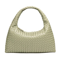 Beige woven leather handbag with single top handle on white background