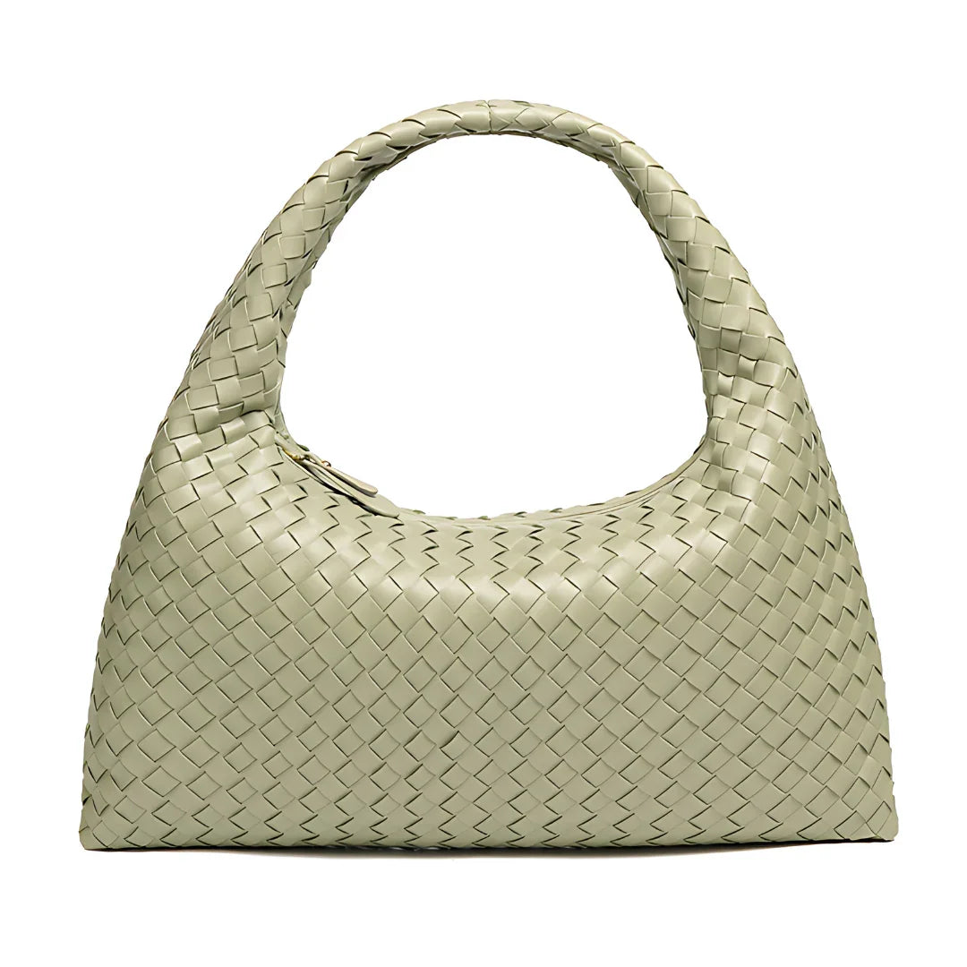 Beige woven leather handbag with single top handle on white background