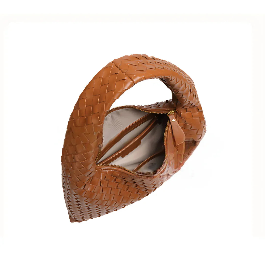 Brown woven leather handbag with open zipper showing inner pockets on white background