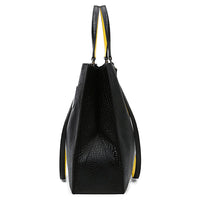 Side view of black textured leather tote bag with yellow interior on white background