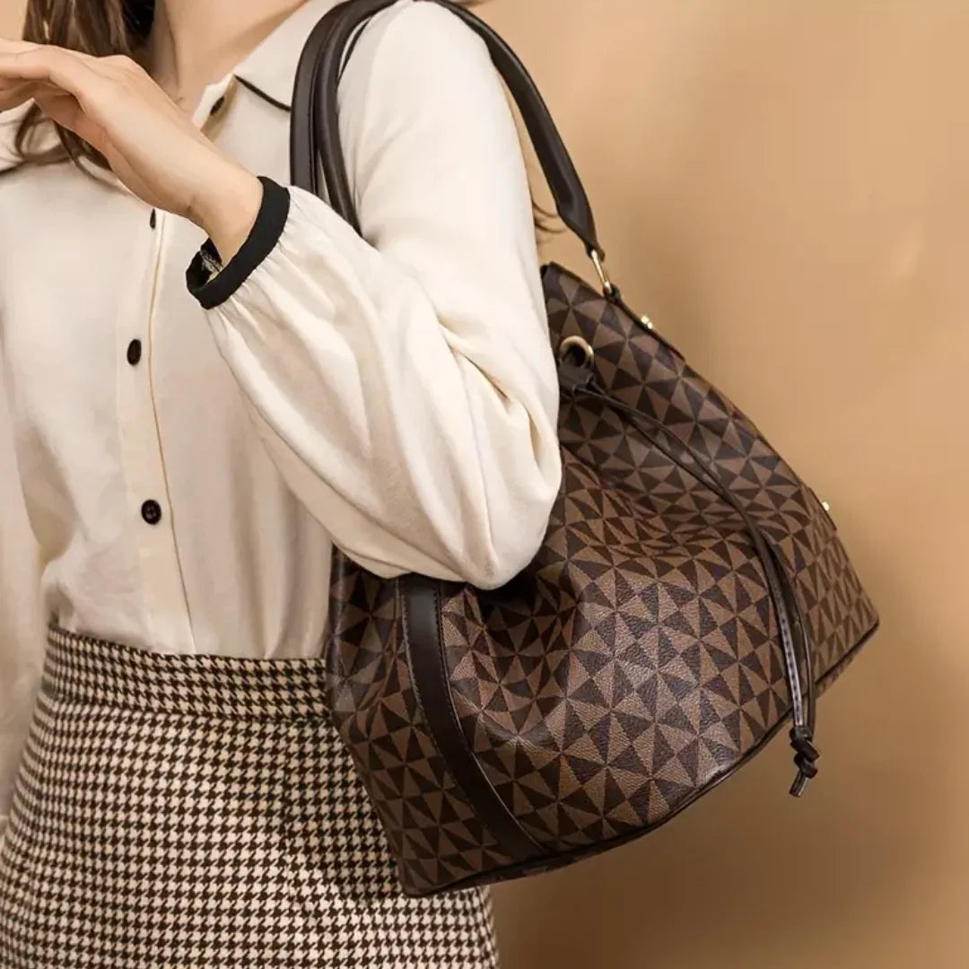 Woman wearing white blouse and houndstooth skirt with geometric brown tote bag