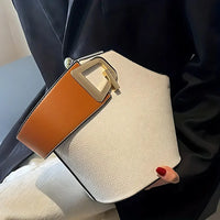 Modern white leather handbag with wide tan strap and gold buckle detail