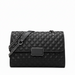 Black quilted leather handbag with chain strap and rectangular metal clasp on white background