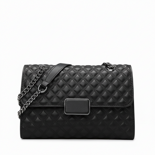 Black quilted leather handbag with chain strap and rectangular metal clasp on white background