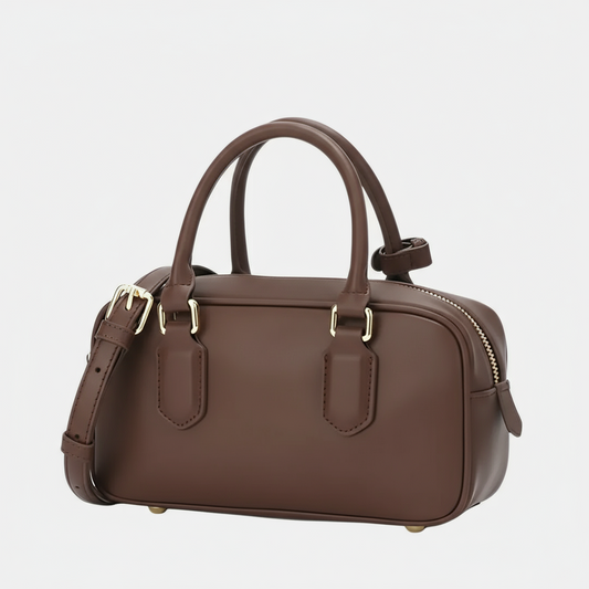 Brown leather handbag with gold hardware, top handles, detachable strap on white background