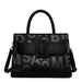 Black leather handbag with bold embossed letters, top handle, and detachable strap