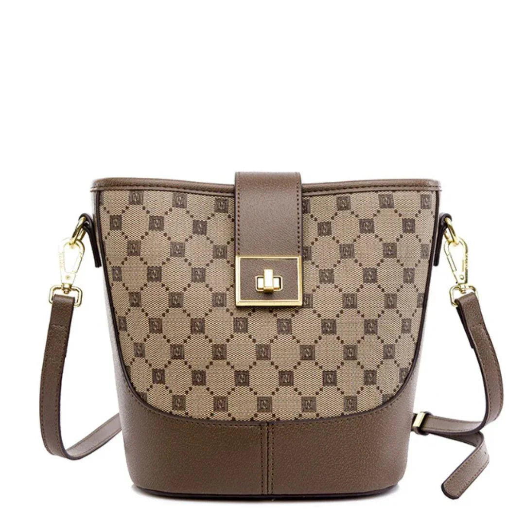 Brown designer crossbody bag with gold hardware and geometric pattern on white background