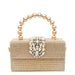 Gold beaded clutch purse with jeweled clasp and round metallic handle on white background