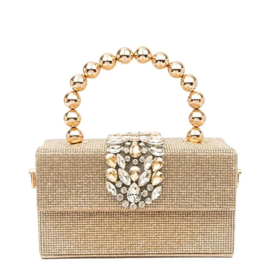 Gold beaded clutch purse with jeweled clasp and round metallic handle on white background