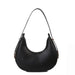 Black crescent shoulder bag with minimalist design on white background