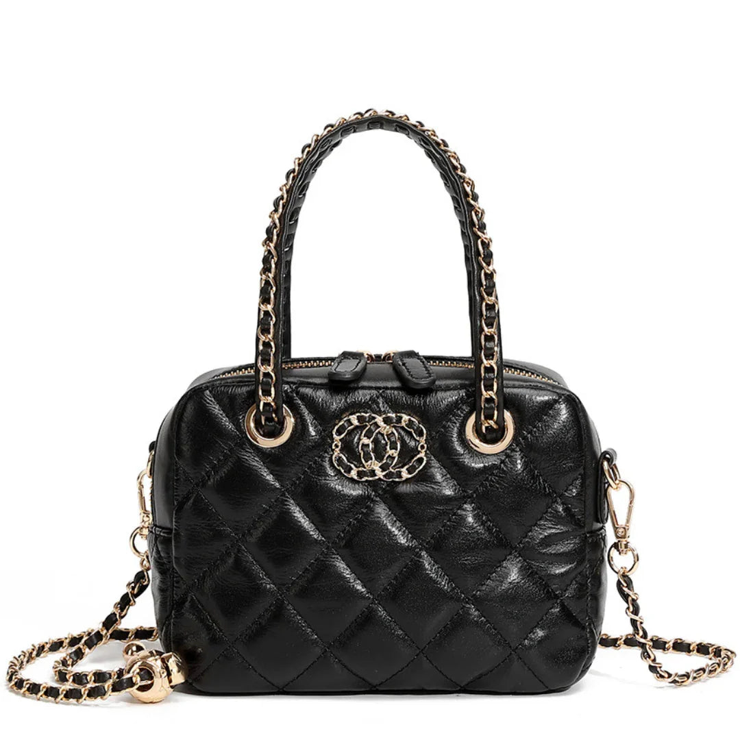 Black quilted leather handbag with gold chain handles and logo, luxury fashion accessory