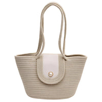 Beige woven straw tote bag with double handles and pearl button closure
