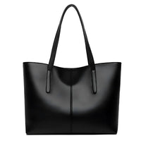 Black leather tote bag with double handles, minimalist and sleek design