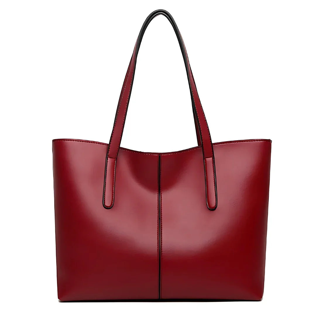 Elegant red leather tote bag with double handles on a white background