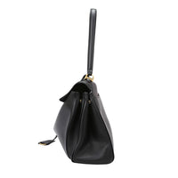 Black leather handbag with gold hardware, side view, structured purse design