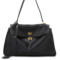 Black leather shoulder bag with gold hardware and top handle on white background