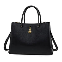 Black leather tote bag with gold medallion charm and dual top handles
