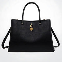Black textured leather handbag with gold medallion accent and double handles