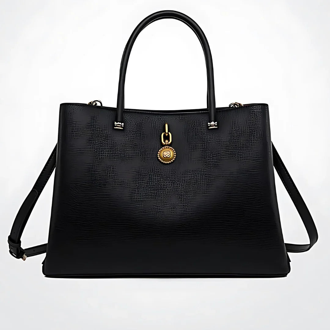 Black textured leather handbag with gold medallion accent and double handles