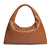 Brown woven leather hobo bag with curved handle on a white background