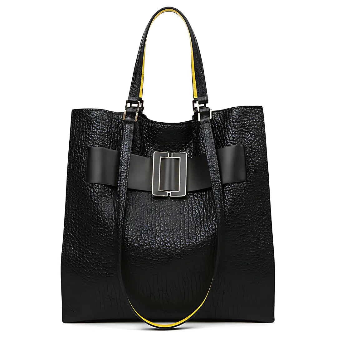 Black textured leather tote bag with wide buckle detail and yellow-lined handles