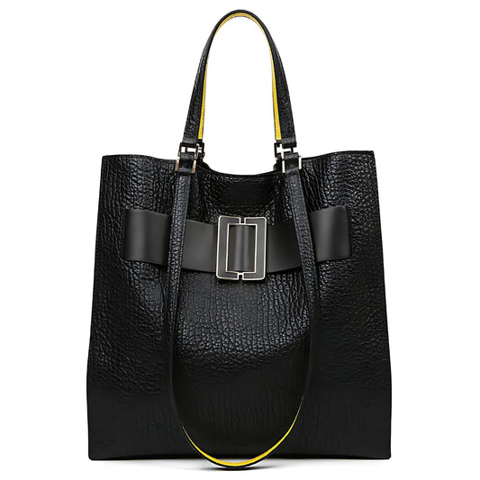 Black textured leather tote bag with wide buckle detail and yellow-lined handles