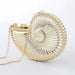 Gold metallic shell-shaped clutch bag with chain strap on white background