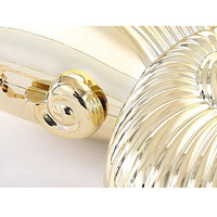 Close-up of a shiny gold decorative vase with textured spiral detail