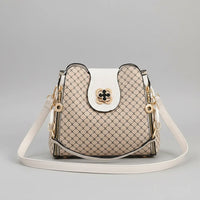 Beige designer crossbody bag with geometric pattern and white leather strap