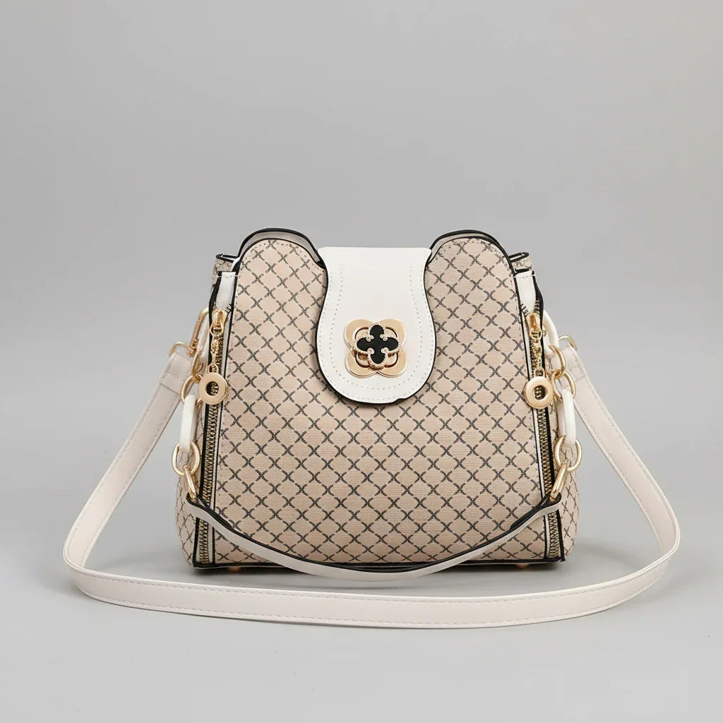 Beige designer crossbody bag with geometric pattern and white leather strap