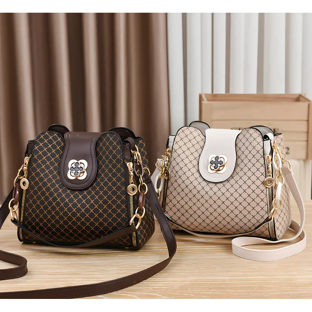 Two patterned shoulder handbags with gold hardware on a wooden table, brown and beige colors