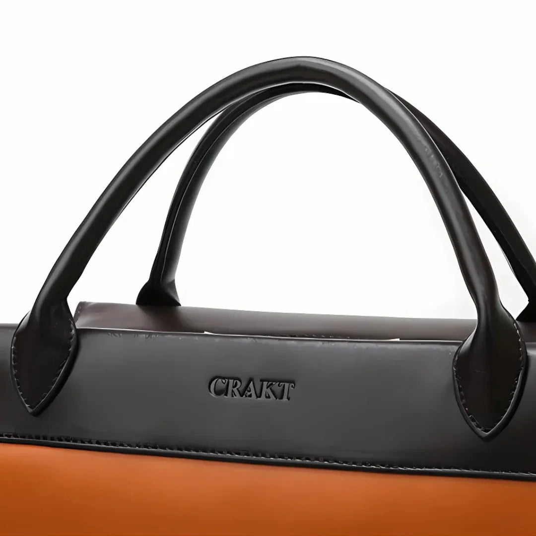 CRAKT black and brown leather handbag with dual handles, close-up view