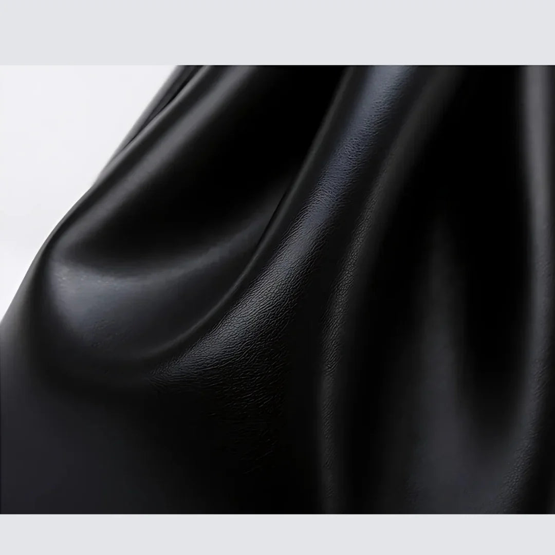 Smooth black faux leather fabric with soft light reflection