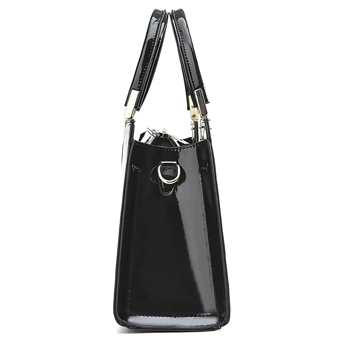 Glossy black patent leather tote bag with gold hardware, side view