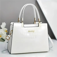 Elegant white leather handbag with gold hardware and double handles on modern background