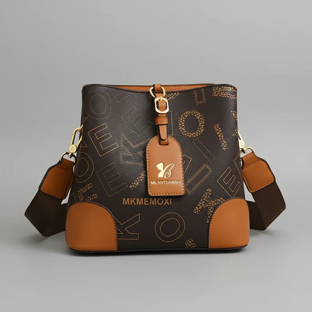 Brown MKMEMOXI crossbody bag with gold hardware and MILANTUANSHI tag on grey background