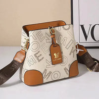 Beige and brown designer shoulder bag with bold lettering and gold butterfly tag