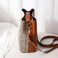 Brown leather and tweed shoulder bag with gold hardware on a white background