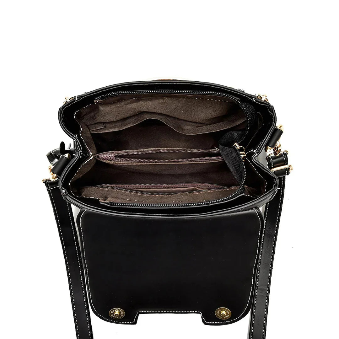 Open black leather crossbody bag with multiple brown inner pockets and gold hardware