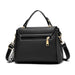 Black leather handbag with gold zipper, handle, adjustable strap, and white stitching