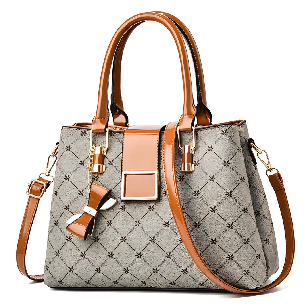 Elegant brown leather handbag with patterned gray fabric, bow detail, and gold hardware