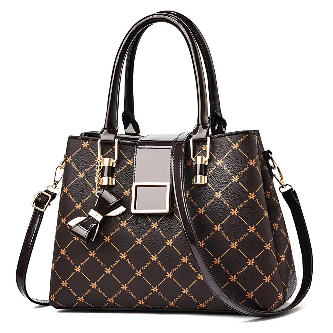 Elegant black and gold patterned handbag with top handles and bow charm