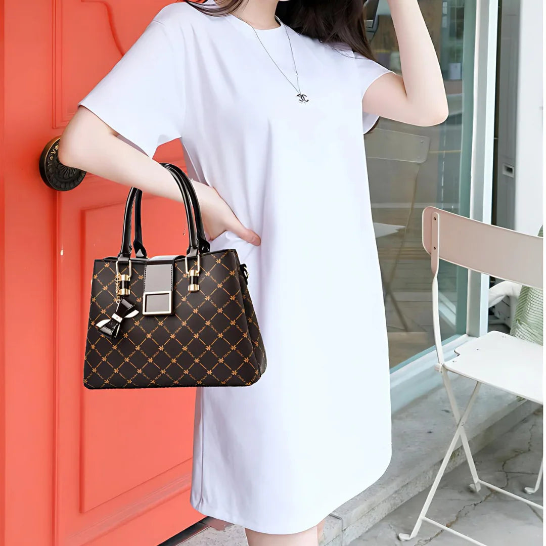 Woman in white dress holding black patterned handbag by orange door