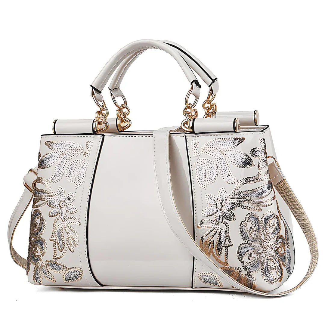 White handbag with gold hardware and silver floral sequin embroidery, elegant purse