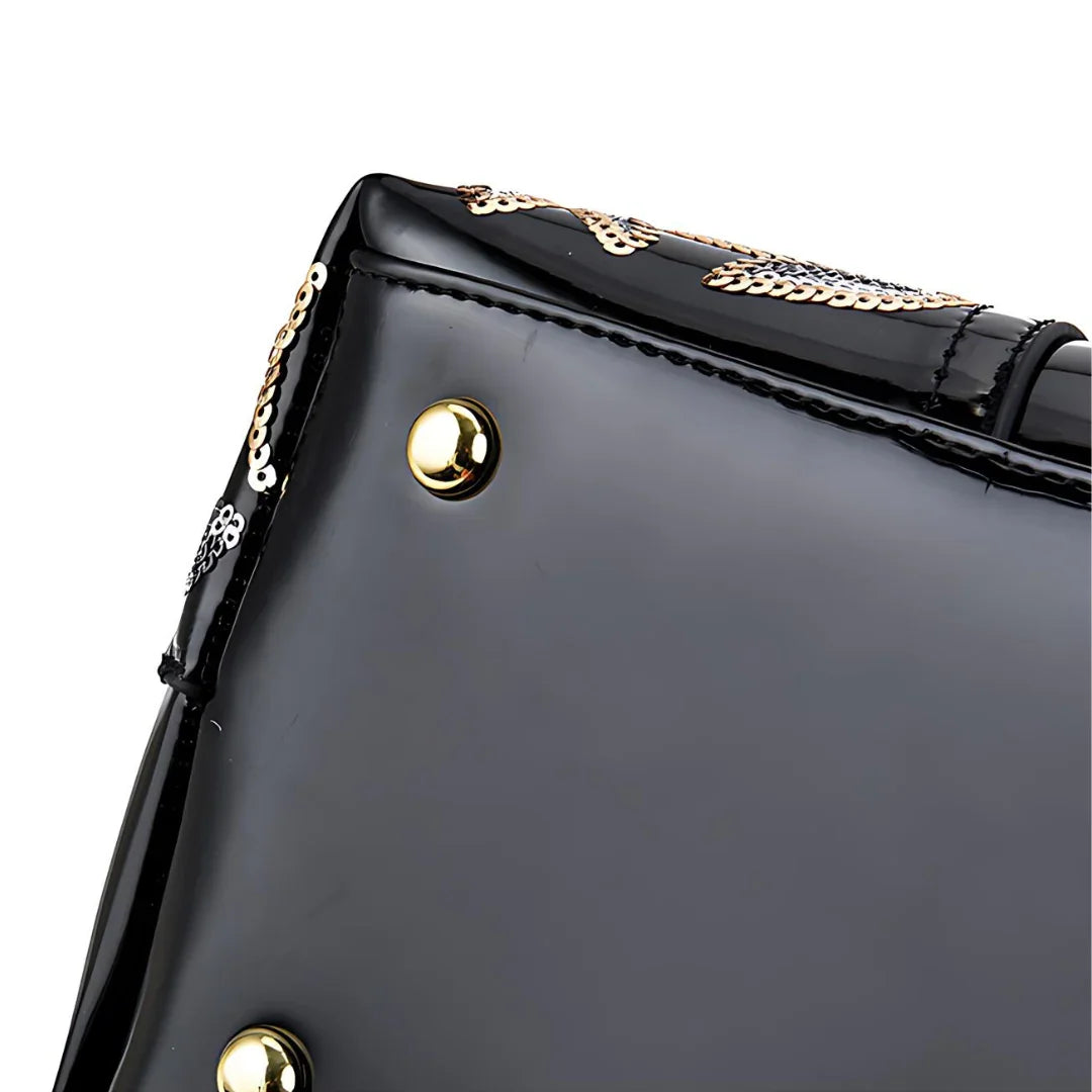 Black patent leather purse corner with gold studs and sequin floral accents