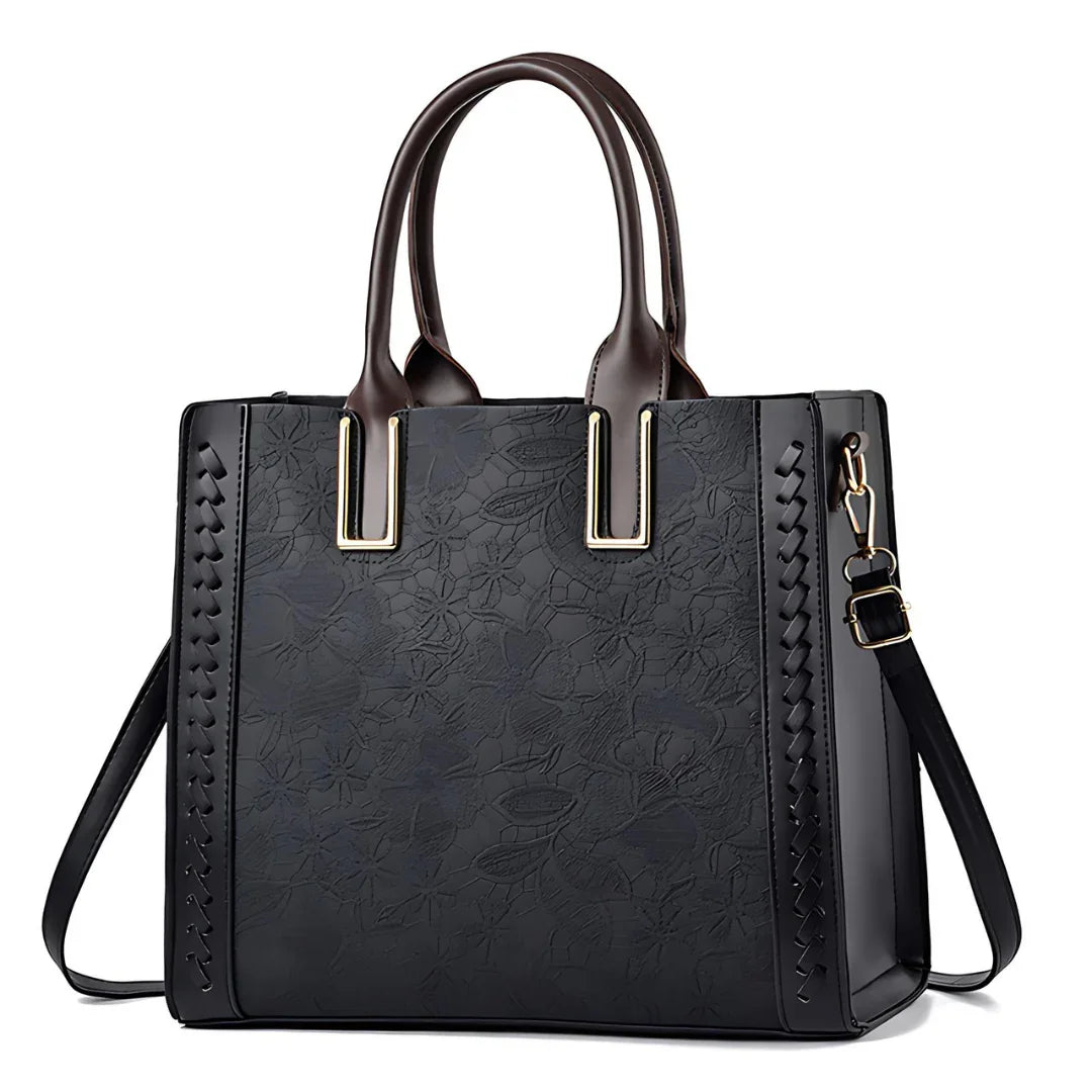 Black floral embossed leather tote bag with double handles and gold hardware