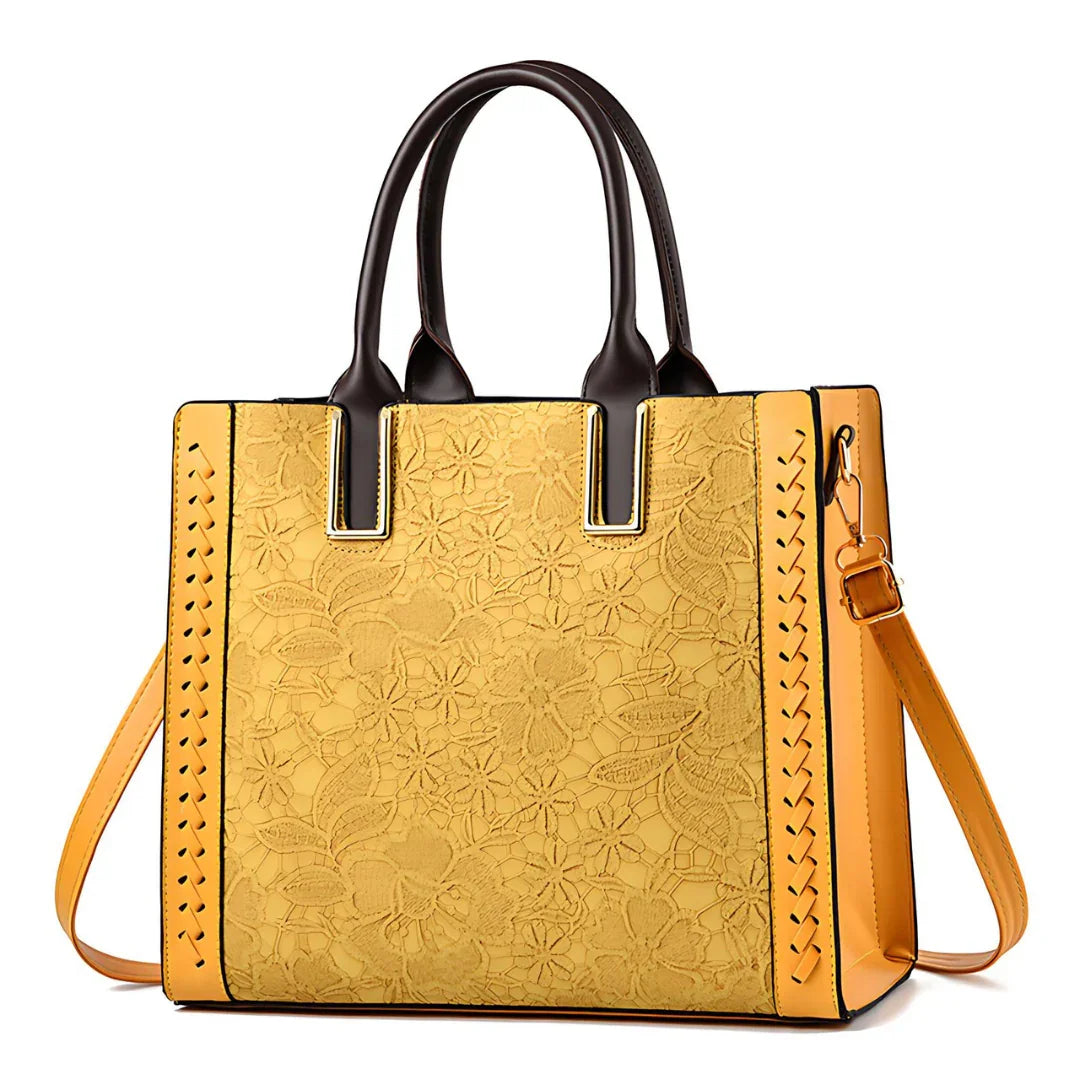 Yellow floral embossed tote bag with brown handles and detachable shoulder strap