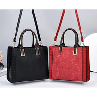 Black and red leather handbags with floral embossed patterns and top handles