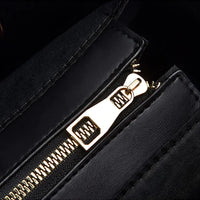 Close-up of gold zipper on black leather bag, luxury handbag accessory detail